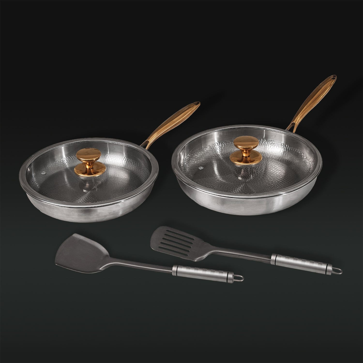Two Titanium frying pans with wooden handles and two metal spatulas
