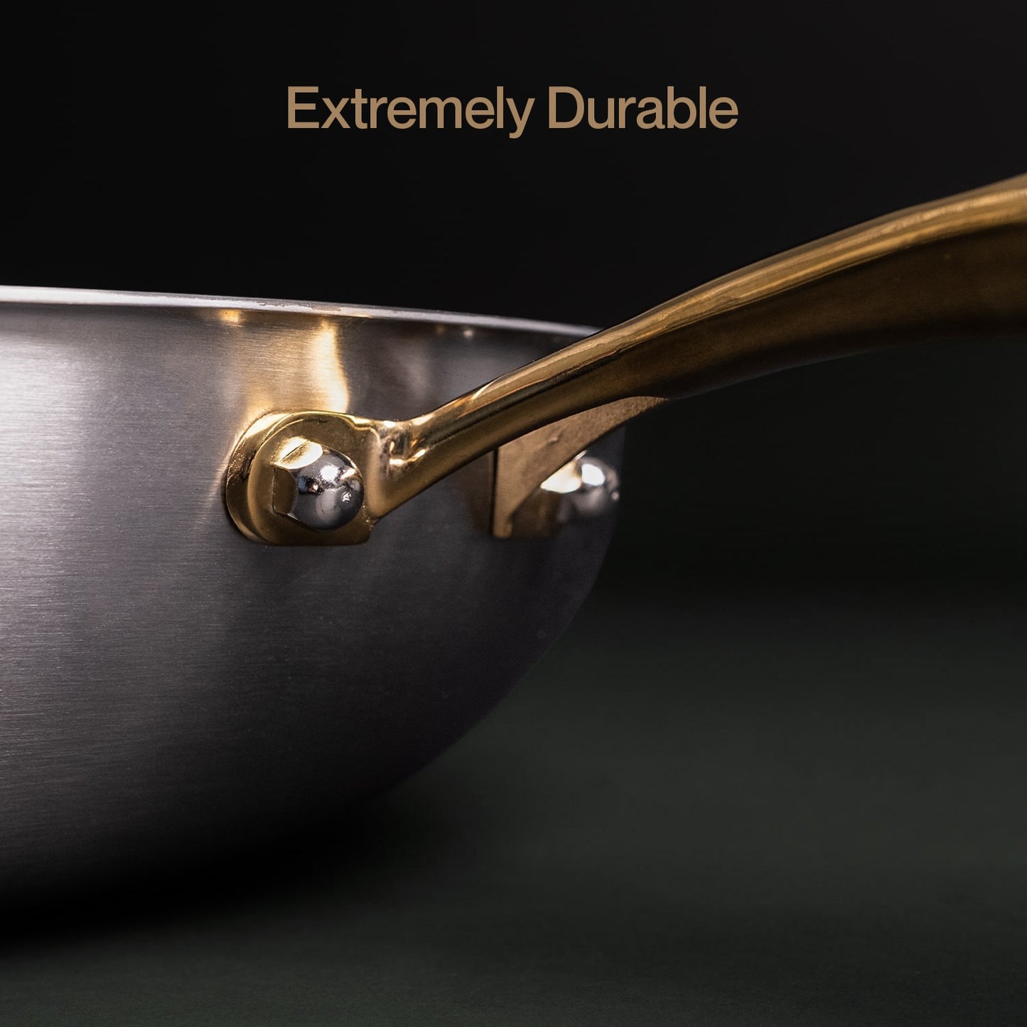 Close-up of a frying pan handle with 'Extremely Durable' text on a black background