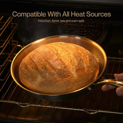 Baked loaf of bread in a pan inside an oven with text 'Compatible With All Heat Sources'.