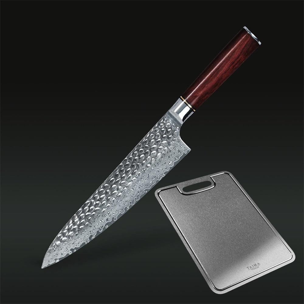 A kitchen knife with a hammered Damascus steel blade and a dark reddish-brown wooden handle, shown diagonally next to a rectangular metal cutting board on a dark gradient background.