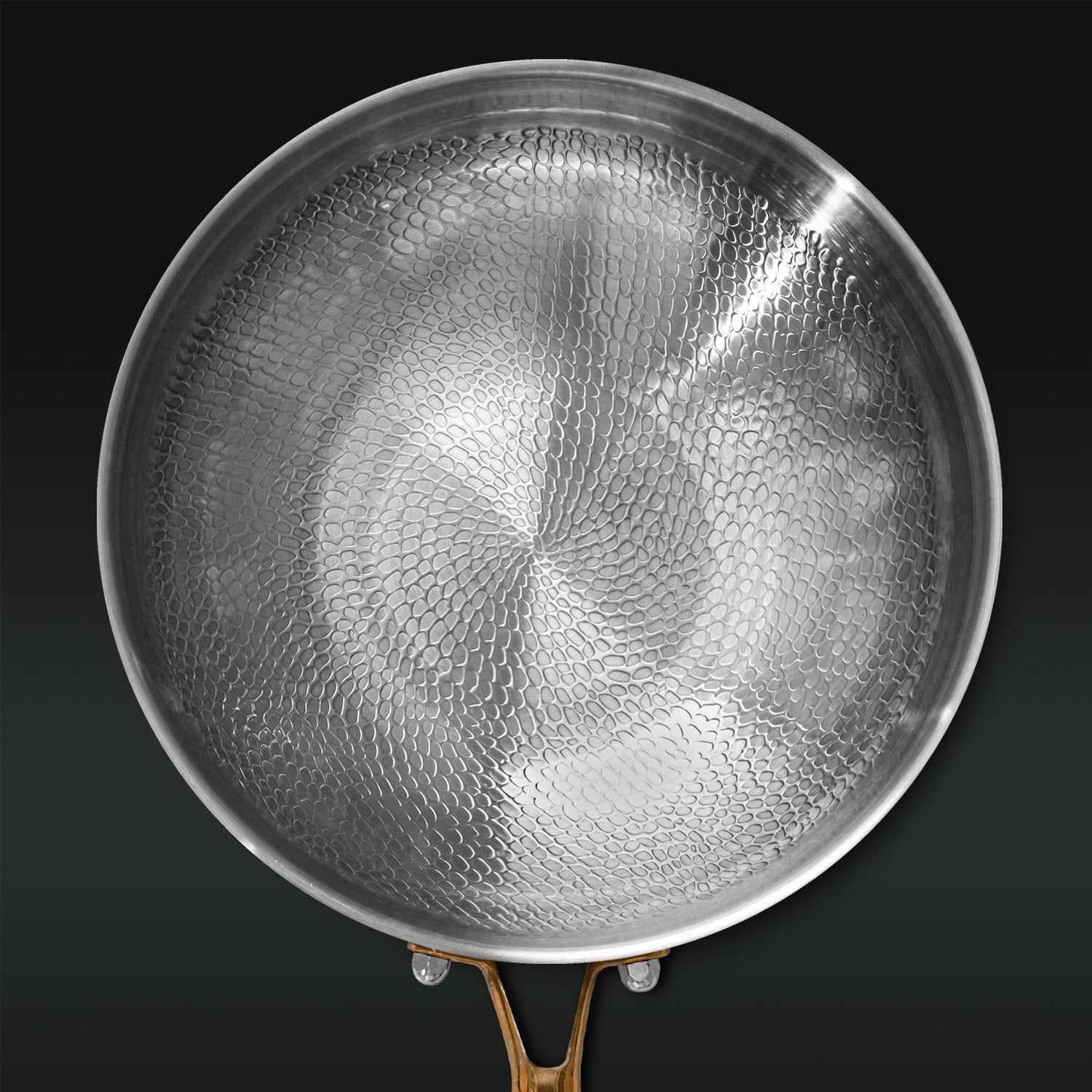 Titanium pan with textured surface on a black background